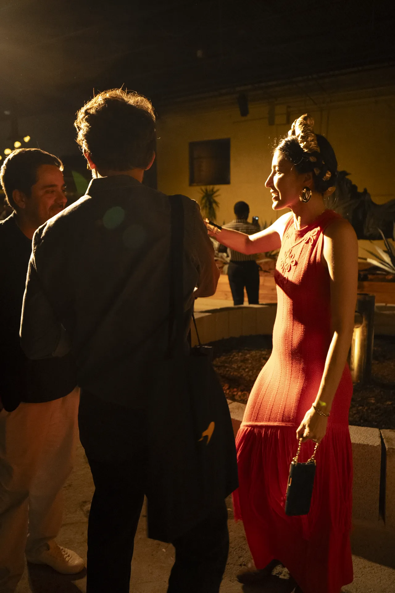 Guests chatting in warm evening light at Tequila Town's VIP preview
